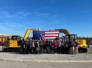 Thompson Machinery Employees in front of an amercian flag